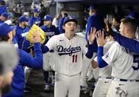 ７回を投げ終え、ベンチで迎えられる佐々木（共同）