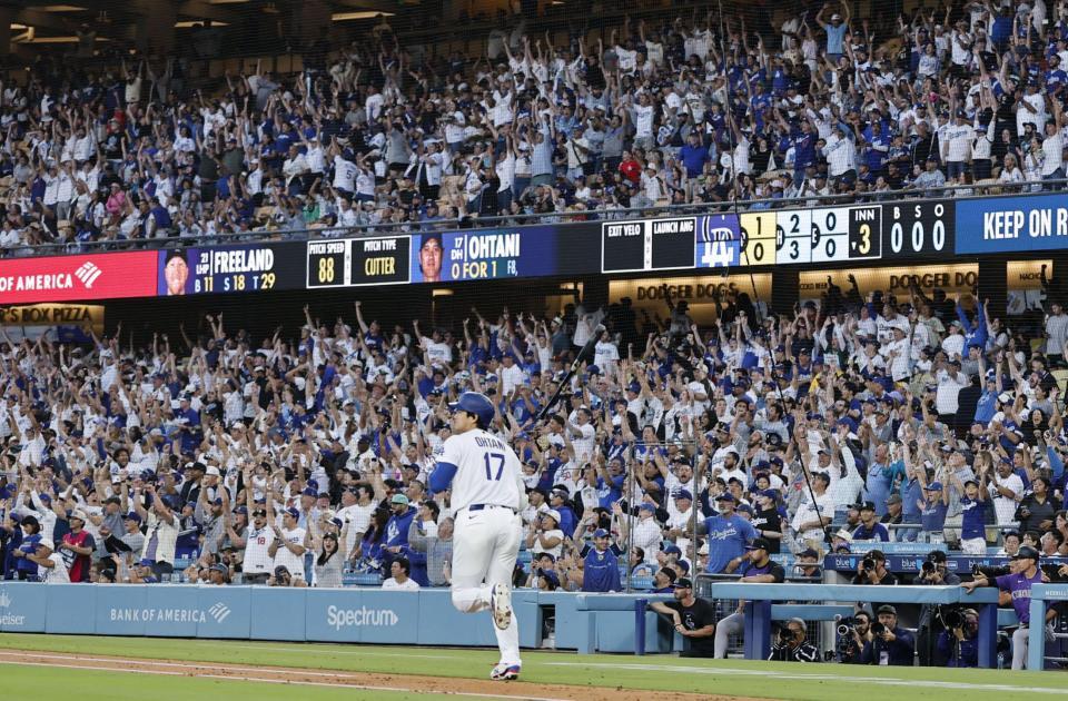 　ロッキーズ戦の３回、ドジャース・大谷（中央）の19号２ランに沸くスタンドのファン（共同）
