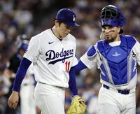ロッキーズ戦の６回を投げ終え、ベンチに戻るドジャース・佐々木。右は捕手アルフォンソ（共同）