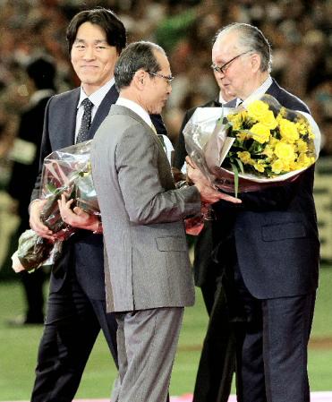 　国民栄誉賞を受賞し、王貞治氏（中央）から祝福の花束を受け取る長嶋茂雄氏。左はともに受賞した松井秀喜氏＝５日午後、東京ドーム