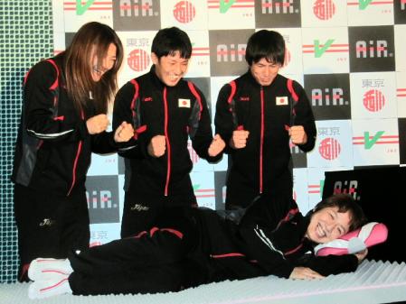 　笑顔でベッドに横たわる浜口（手前）に気合を注入する（左から）伊調、長谷川、湯元＝都内