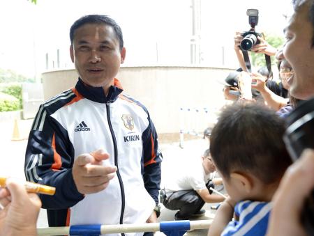 　子供のズボンのまた近くにサインした意図を「金メダル？」とファンに質問されて笑顔で答える佐々木監督（撮影・西岡　正）