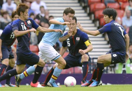 　初戦のスペイン戦で、相手選手を取り囲む日本の（右から）山村、吉田、山口（共同）