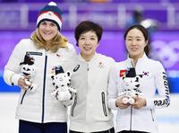 　女子５００メートルで金メダルを獲得した小平奈緒。右は２位の韓国の李相花、左は３位のチェコのカロリナ・エルバノバ＝江陵（共同）