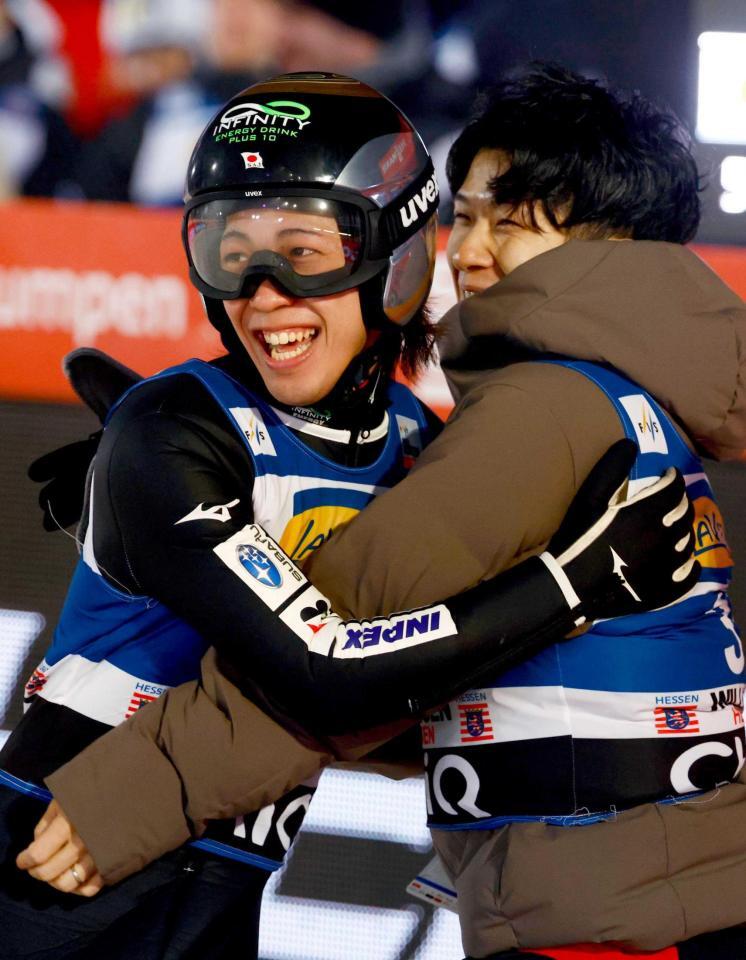 　２回目の飛躍を終え、佐藤幸椰（右）と抱き合う二階堂蓮（共同）