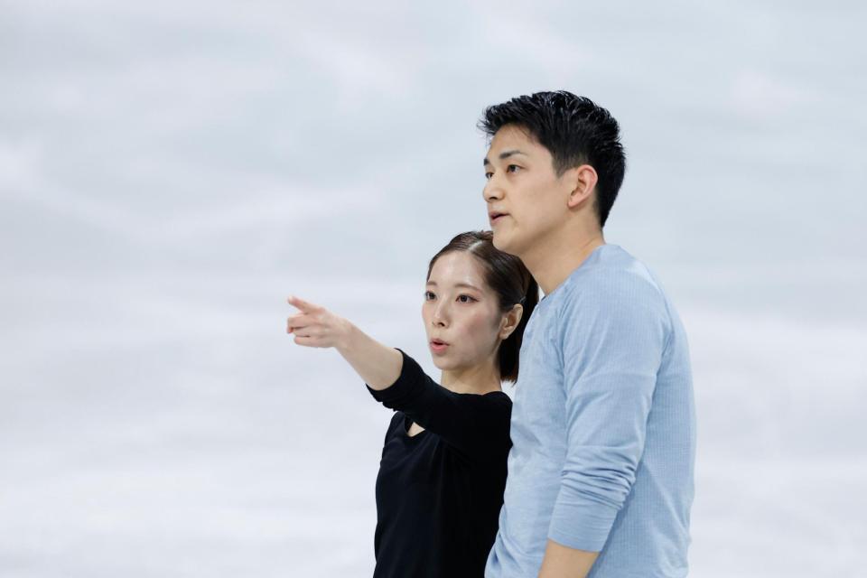 公式練習で言葉を交わすペアの三浦璃来（左）、木原龍一組（共同）