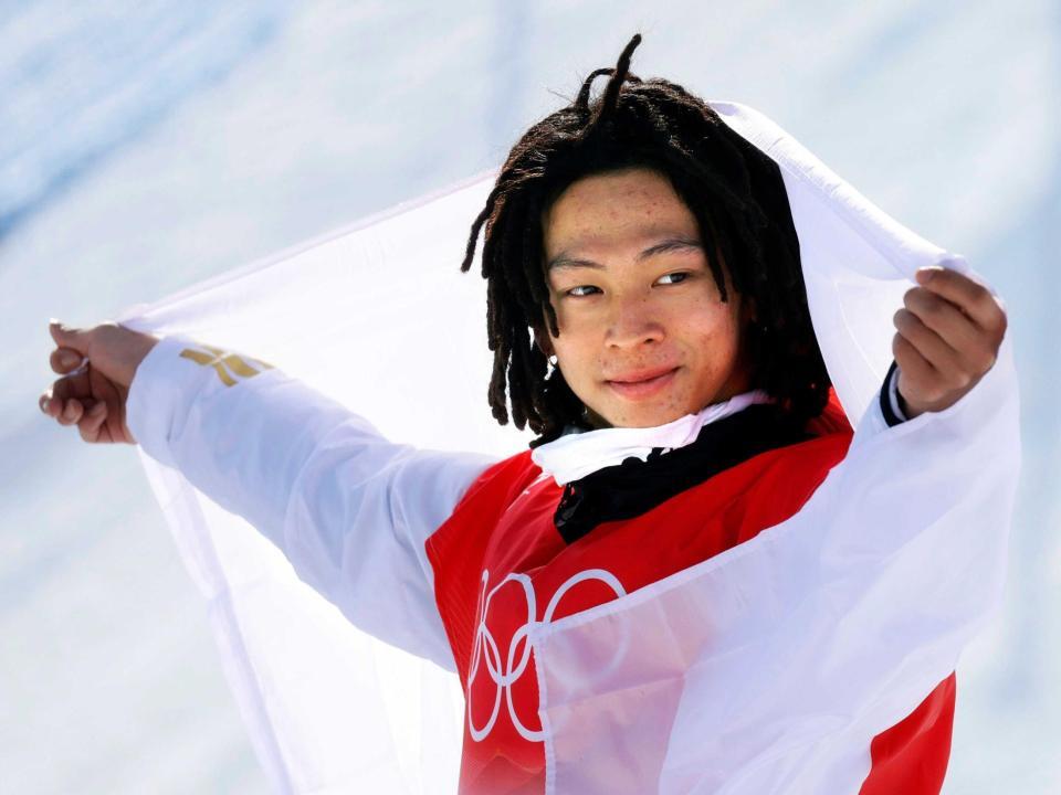 　北京冬季五輪スノーボード男子ハーフパイプで金メダルを獲得し、日の丸を広げる平野歩夢＝２０２２年２月（共同）