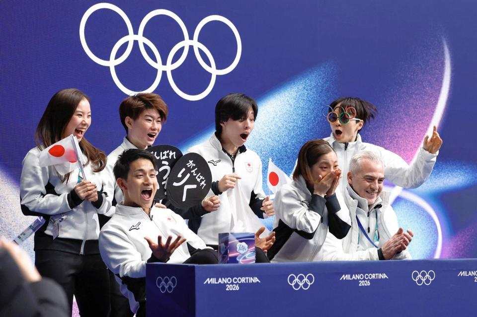 団体ペア・フリーの得点を確認し、驚く三浦璃来（前列中央）、木原龍一（同左）組と喜ぶ鍵山優真（後列右端）ら日本チーム＝ミラノ（共同）