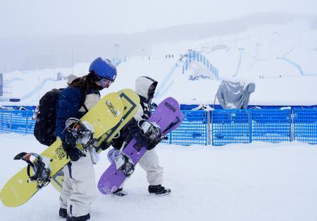 　女子スロープスタイル決勝が悪天候のため延期となり、引き揚げる深田茉莉（左）、岩渕麗楽＝リビーニョ（共同）