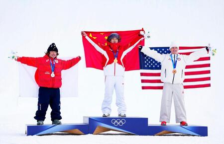 男子スロープスタイルで銀メダルを獲得し、表彰台で日の丸を掲げる長谷川帝勝（左）＝リビーニョ（共同）