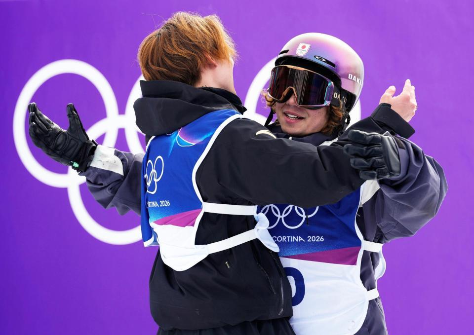 男子スロープスタイルでメダル獲得を確信し、蘇翊鳴（左）と抱き合う長谷川帝勝＝リビーニョ（共同）