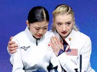 女子フリーの順位確定を待つ間、アンバー・グレン（右）に肩を抱かれる千葉百音＝ミラノ（共同）
