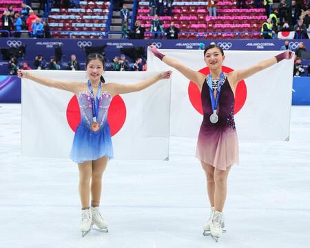 笑顔で日の丸を掲げる銀メダルの坂本花織（右）と銅メダルの中井亜美＝１９日