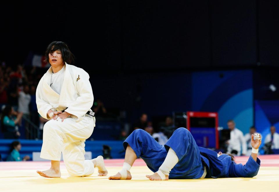 　女子70キロ級２回戦で初戦でウズベキスタン選手（右）に一本勝ちした新添左季（共同）