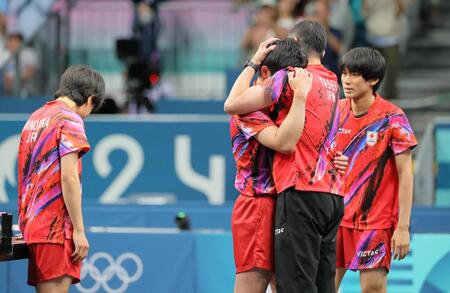 　決勝進出を逃し、田勢監督に抱きつく張本智和（中央左）。左は篠塚大登、右は戸上隼輔（撮影・吉澤敬太）