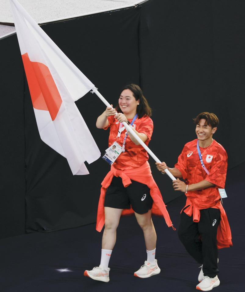 　パリ五輪の閉会式で、日の丸を手に入場する旗手の北口榛花（左）と半井重幸＝11日、パリ郊外（共同）(1)