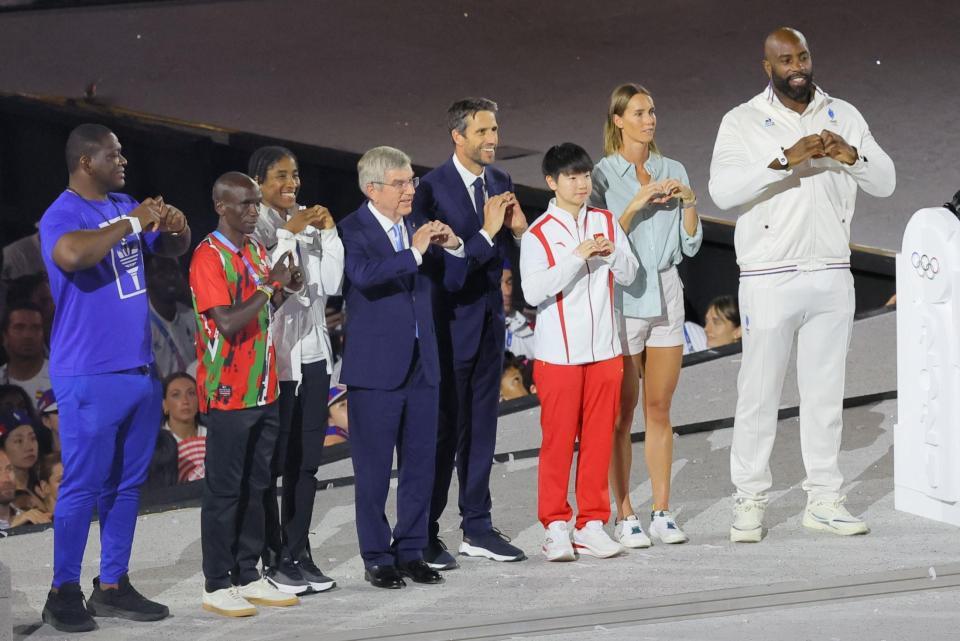 　フランスのリネール（右端）、中国の孫頴莎（右から３人目）らとハートマークを作るＩＯＣのバッハ会長（中央）＝撮影・吉澤敬太