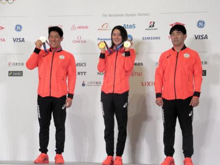 会見でメダルを掲げる（左から）本多、大橋。右は平井コーチ