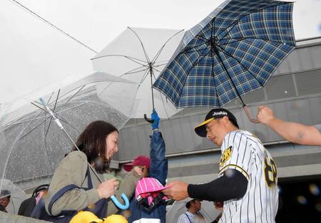 雨が降る中、ファンにサインする矢野監督＝２月１９日