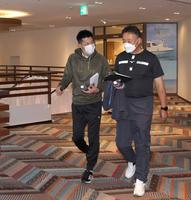 　ミーティングへ向かう矢野監督（左）＝球団提供