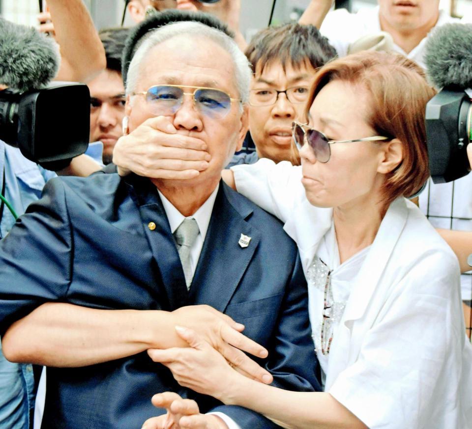 　騒動のさなか、妻（右）に口元を押さえられながら自宅へ戻る日本ボクシング連盟の山根明会長（１８年８月８日）