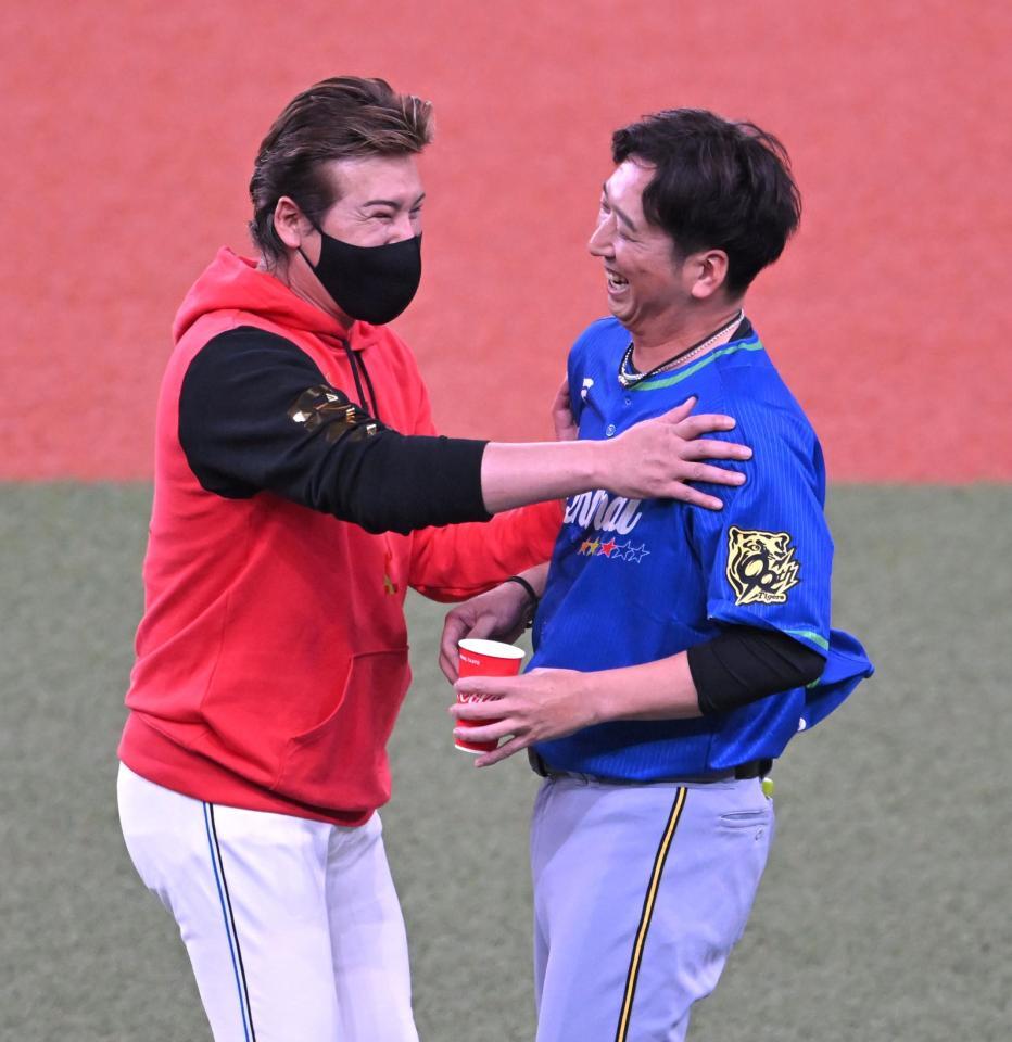 　阪神・藤川監督（右）と談笑する日本ハム・新庄監督＝２３日