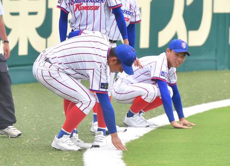 ランニングを終え、外野の天然芝を触る下関国際の野球部員たち＝甲子園（撮影・伊藤笙子）