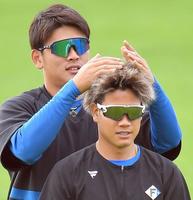 福田俊（手前）のヘアスタイルをいじる日本ハム・野村佑希＝タピックスタジアム名護（撮影・伊藤笙子）