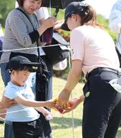 ホールアウト後、子どもから「タラタラしてんじゃねーよ」をプレゼントされ、代わりにボールをあげる渋野日向子（右）＝埼玉・石坂ＧＣ（撮影・伊藤笙子）