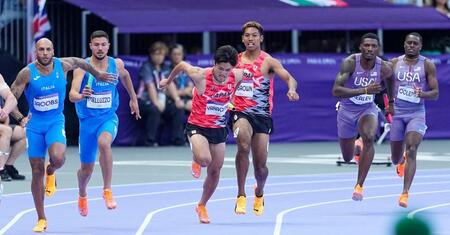 　男子４００メートルリレー予選で、第１走者のサニブラウン・ハキーム（中央右）からバトンを受け取る第２走者の柳田大輝（共同）