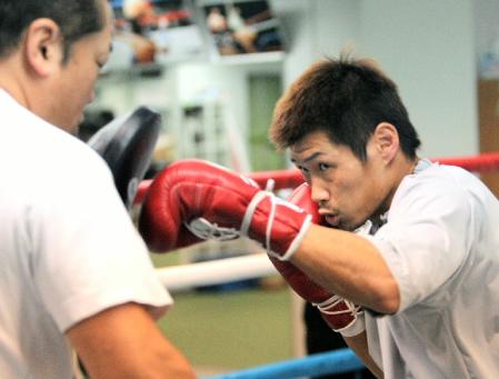 試合に向け懸命にミットを打つ長谷川穂積（撮影・飯室逸平）