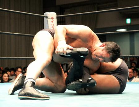 船木誠勝の足を締め上げる、藤波辰爾（左）＝東京・後楽園ホール