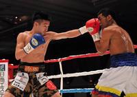 １回、小西怜弥（左）の左がカニサレスの顔面をとらえる＝神戸ポートピアホテル