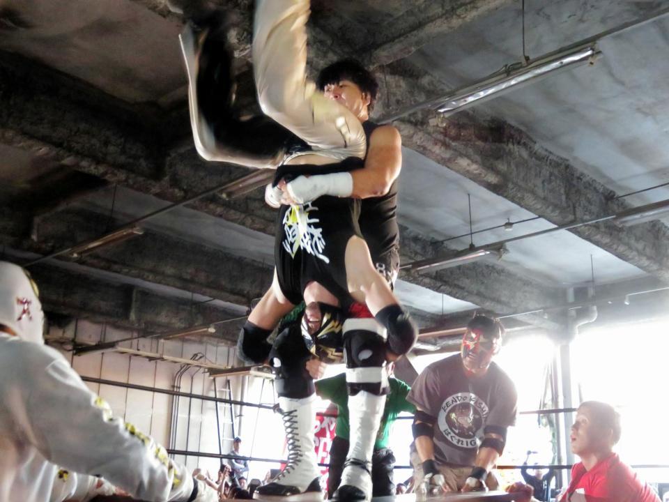 雷電に机上パイルドライバーを放つ大仁田厚＝横浜市の鶴見青果市場