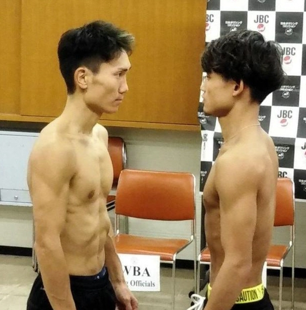 　計量をパスしてにらみ合う京口紘人（右）と久田哲也＝大阪市のエディオンアリーナ大阪