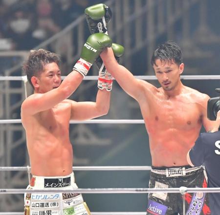 　試合後、判定負けとなった梅野源治（右）の右腕を持ち上げる皇治（撮影・吉澤敬太）