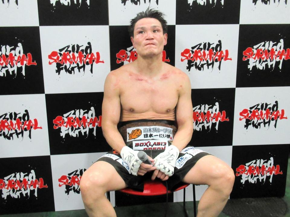 　敗戦後、険しい表情で取材に応じる野中