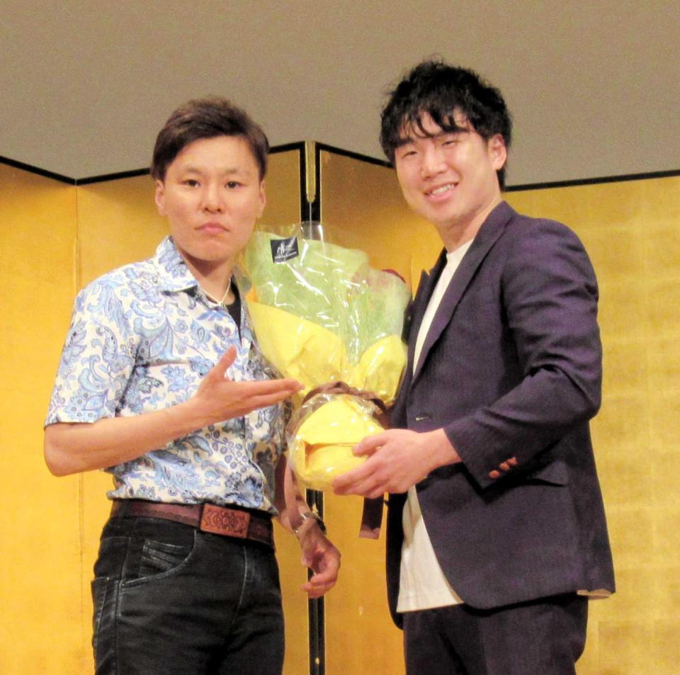 　元女子世界王者の多田悦子さんから花束を受ける寺地拳四朗（右）＝京都市内