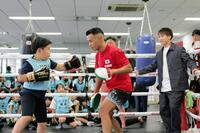 　子供にミット打ちを指導する武居由樹（中）と、見守る井上尚弥（右）（代表撮影）