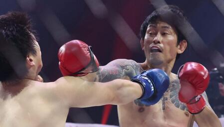 　アマリザ（左）に右ストレートを打ち込む啓之輔（撮影・中田匡峻）