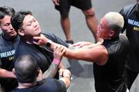 　掴み合いとなるアンディ南野（右）と松井健（左）