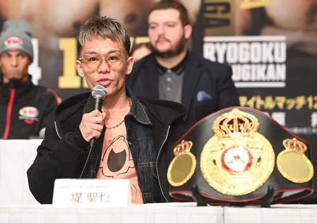 　ベルトの前で決意を語る堤聖也（撮影・園田高夫）