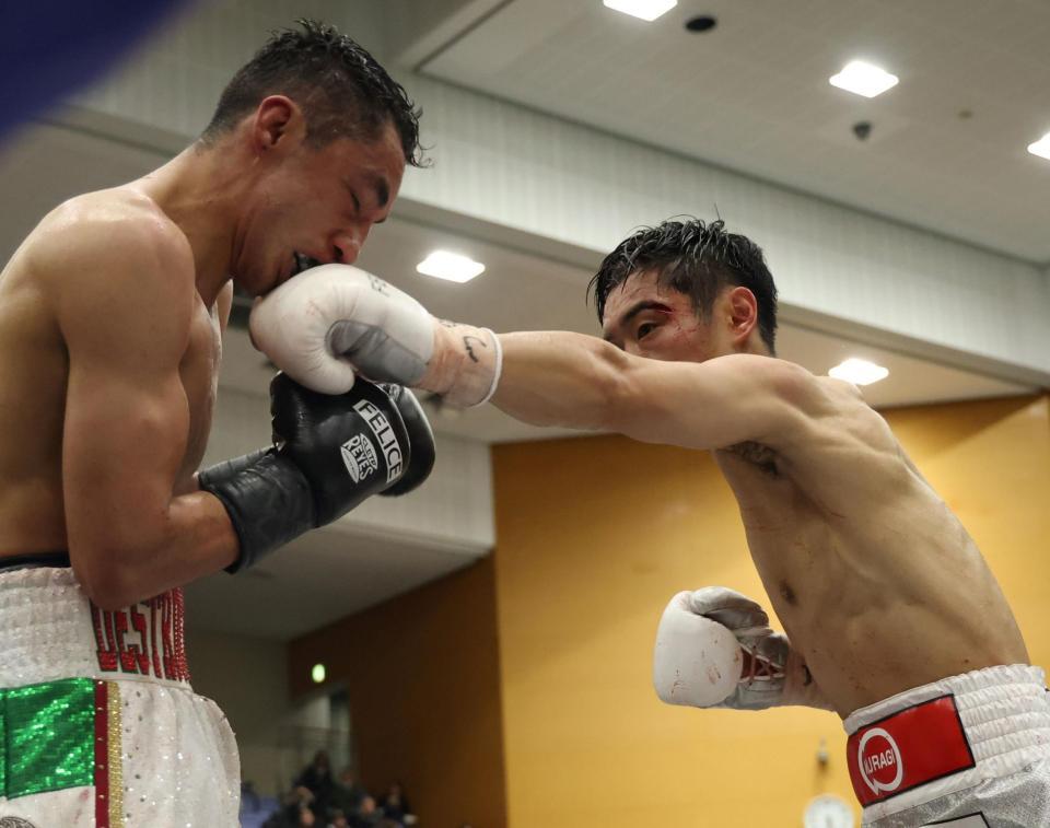 ５Ｒ、ブライアン・メルカド（左）の顔面に打ち込む西田凌佑（撮影・中田匡峻）