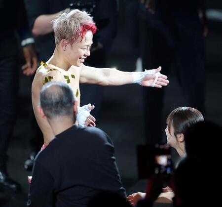 リングを降り、妻の川口葵（右）と笑顔で抱き合う武尊（撮影・吉澤敬太）