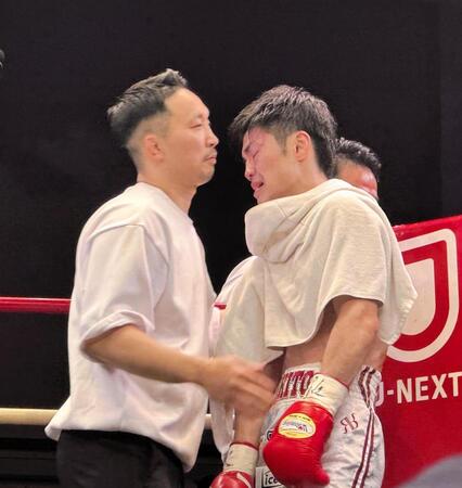 再起戦で４回ＴＫＯ勝利を飾り、涙を浮かべる中野幹士（右）とねぎらう粟生隆寛トレーナー