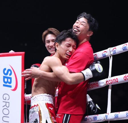 勝利を決めて八重樫東トレーナー（右）と抱き合う石井武志（撮影・伊藤笙子）