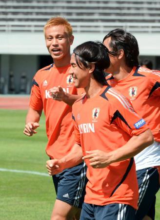 　ランニングで岡崎（手前）と笑顔で話す本田（左）＝新潟市内の競技場（撮影・三好信也）