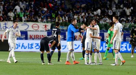 優勝して喜ぶボスニアのイレブンとガックリうな垂れる日本代表イレブン＝吹田市立吹田サッカースタジアム