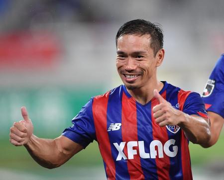 　試合後、サポーターに笑顔でポーズを決めるＦＣ東京・長友（撮影・西岡正）