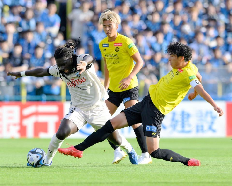 前半、競り合うゴミス（左）と古賀